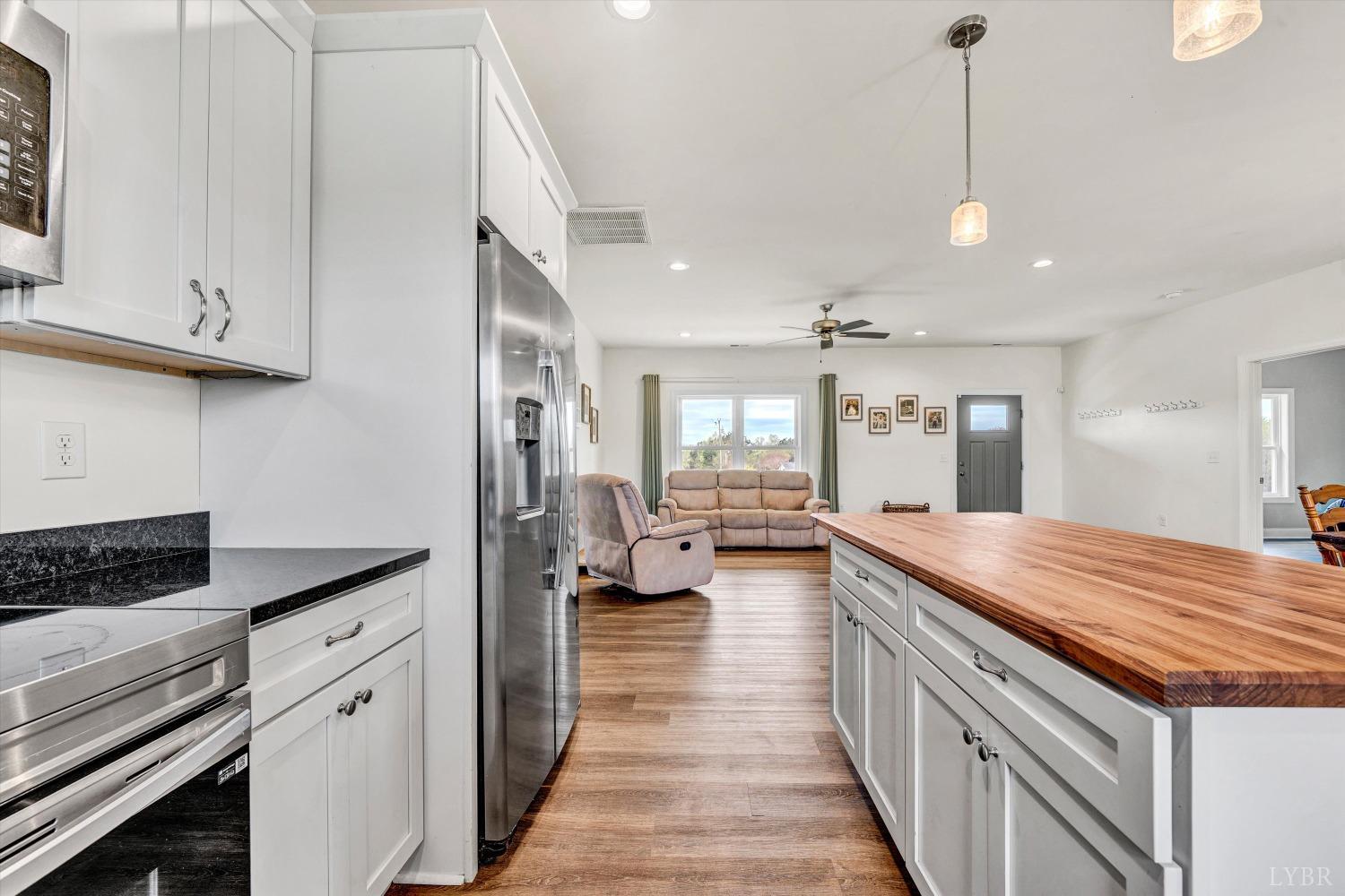 664 Collins Ferry Road Gladys, VA 24554 - Photo 16 of 34 a spacious kitchen with stainless steel appliances granite countertop a lot of counter space and wooden floors