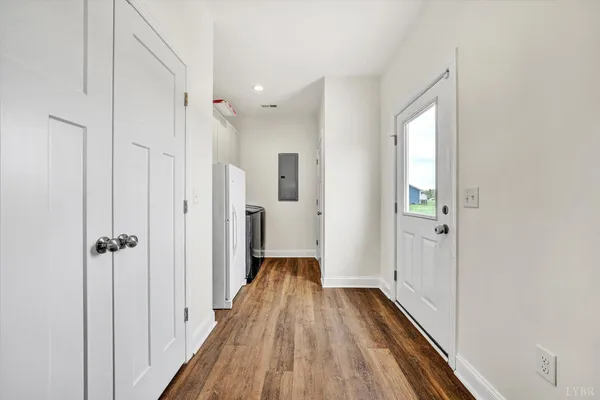 a view of a room with wooden floor