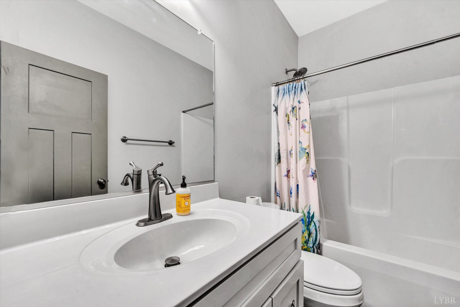 664 Collins Ferry Road Gladys, VA 24554 - Photo 26 of 34 a bathroom with a sink a toilet and shower