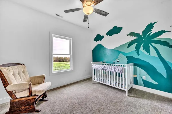 a view of livingroom with furniture and ceiling fan