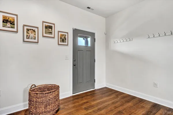 a view of room with window and wooden floor