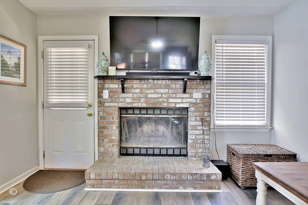 180 Mulberry Lane Fortson, GA 31808 - Photo 11 of 22 a living room with a fireplace and a flat screen tv