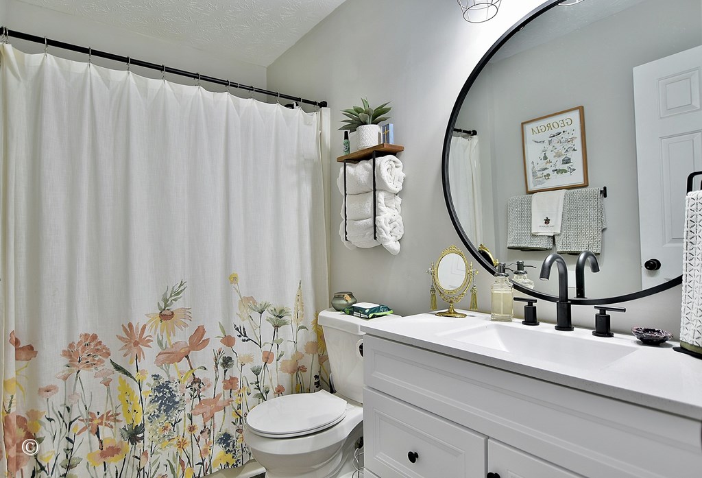 180 Mulberry Lane Fortson, GA 31808 - Photo 12 of 22 a bathroom with a toilet a sink and a mirror