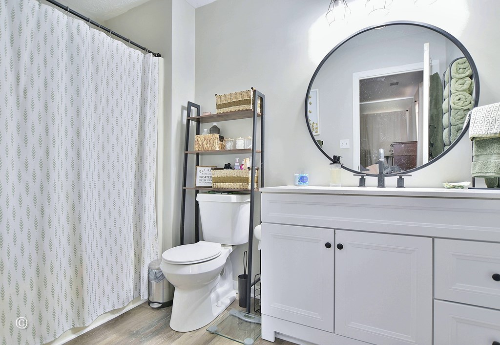 180 Mulberry Lane Fortson, GA 31808 - Photo 15 of 22 a bathroom with a toilet a sink and a mirror
