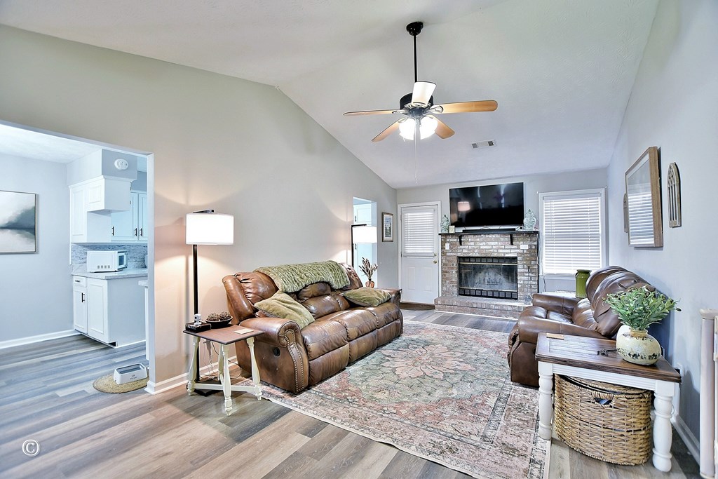 180 Mulberry Lane Fortson, GA 31808 - Photo 6 of 22 a living room with furniture a fireplace and a flat screen tv