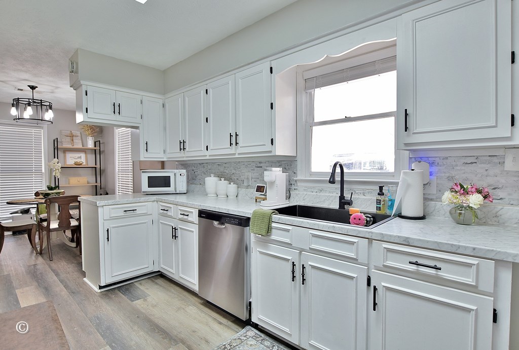 180 Mulberry Lane Fortson, GA 31808 - Photo 10 of 22 a kitchen with cabinets appliances a sink and a window