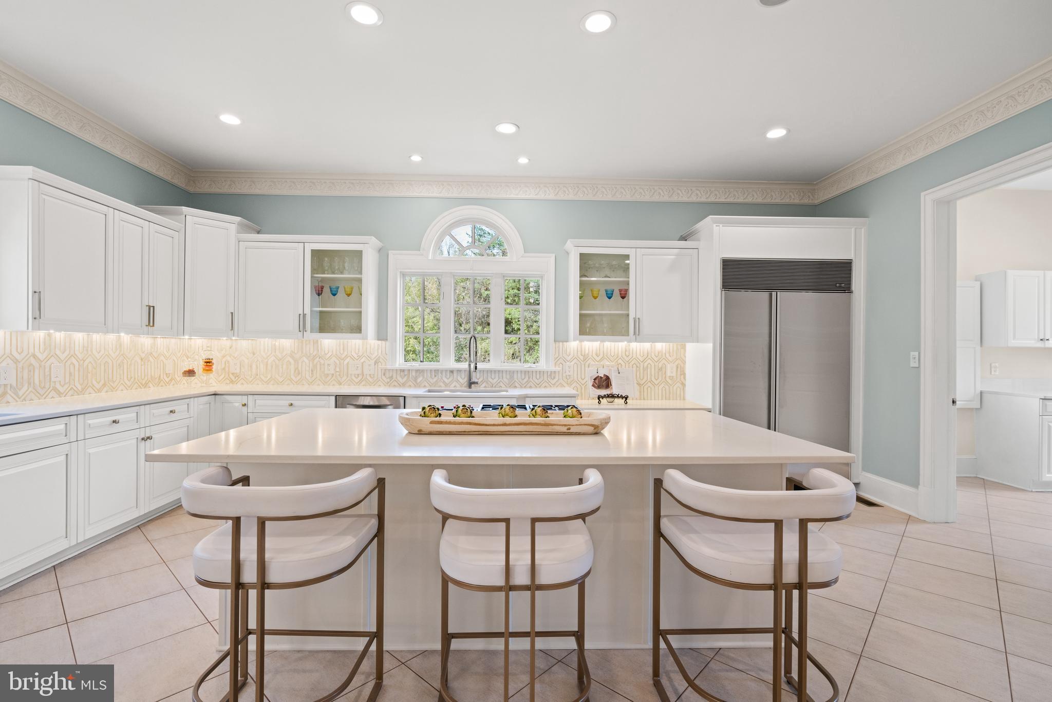 1106 Mill Ridge McLean, VA 22102 - Photo 32 of 85 a kitchen with a dining table chairs cabinets and stainless steel appliances