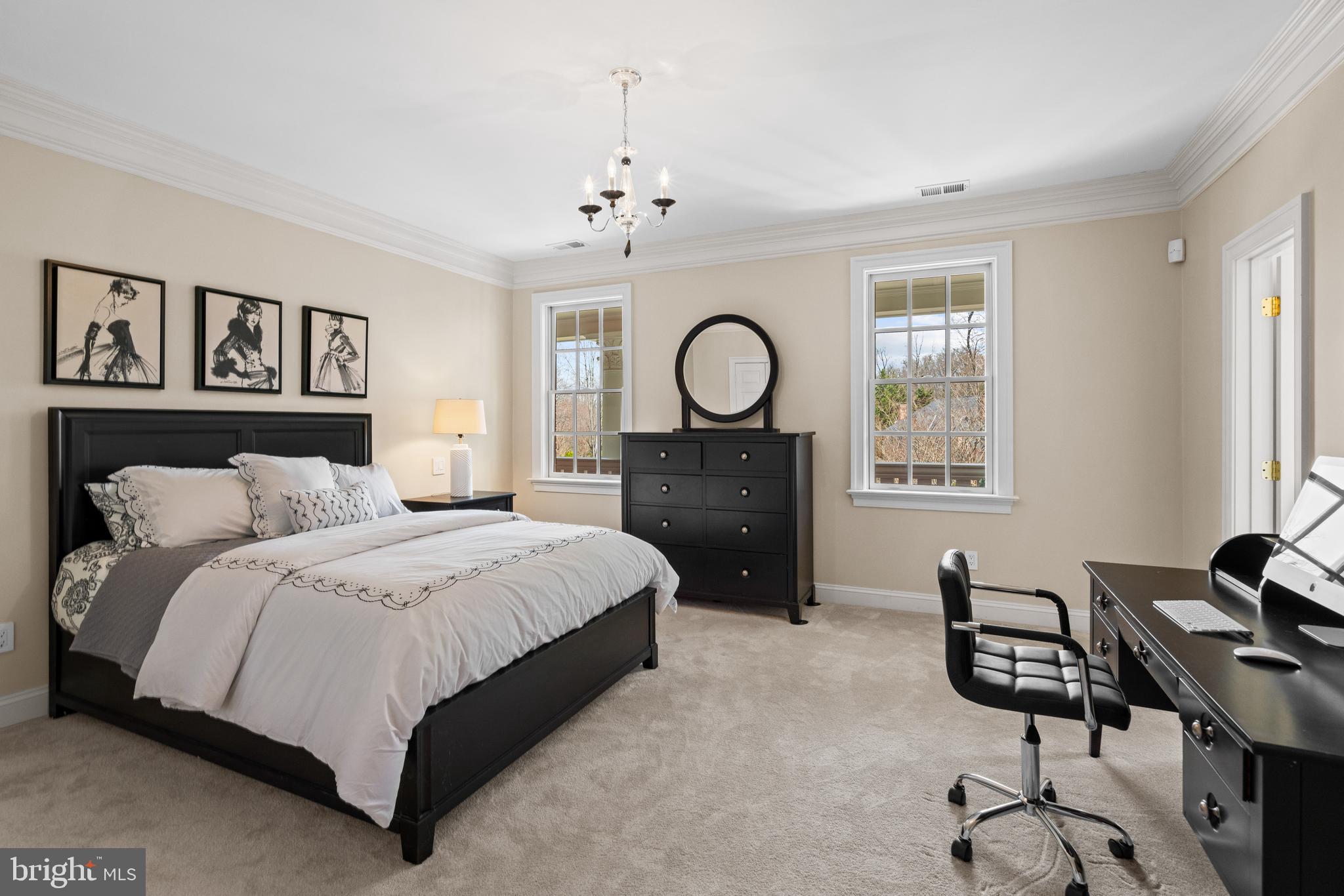 1106 Mill Ridge McLean, VA 22102 - Photo 56 of 85 a spacious bedroom with a bed a clock on dresser and a chandelier