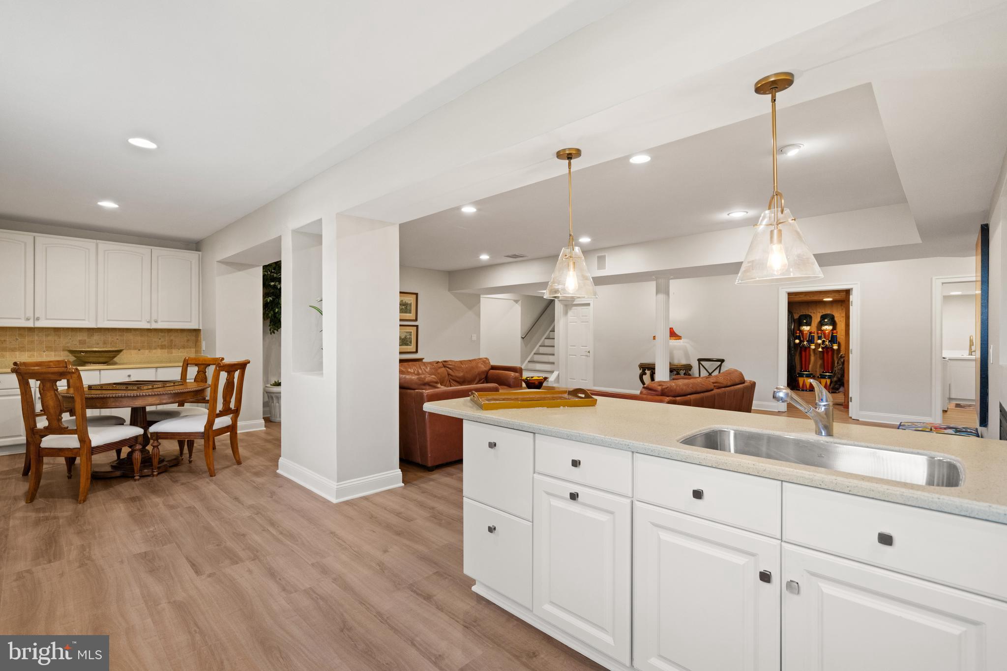 1106 Mill Ridge McLean, VA 22102 - Photo 71 of 85 a kitchen with stainless steel appliances kitchen island granite countertop a stove a sink a dining table and chairs with wooden floor