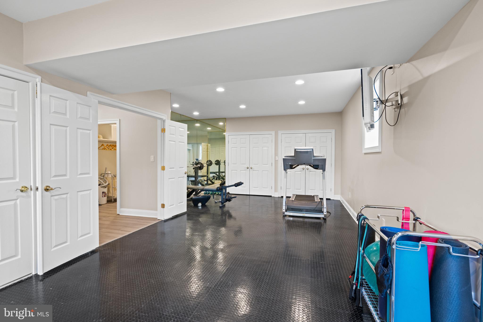 1106 Mill Ridge McLean, VA 22102 - Photo 78 of 85 a view of a room with gym equipment and a chandelier