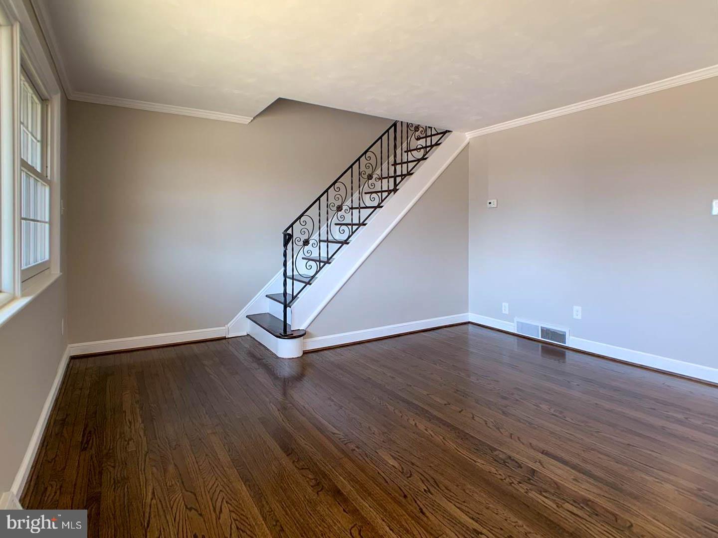 1567 Parklane Road Swarthmore, PA 19081 - Photo 11 of 23 a view of an empty room with wooden floor and stairs