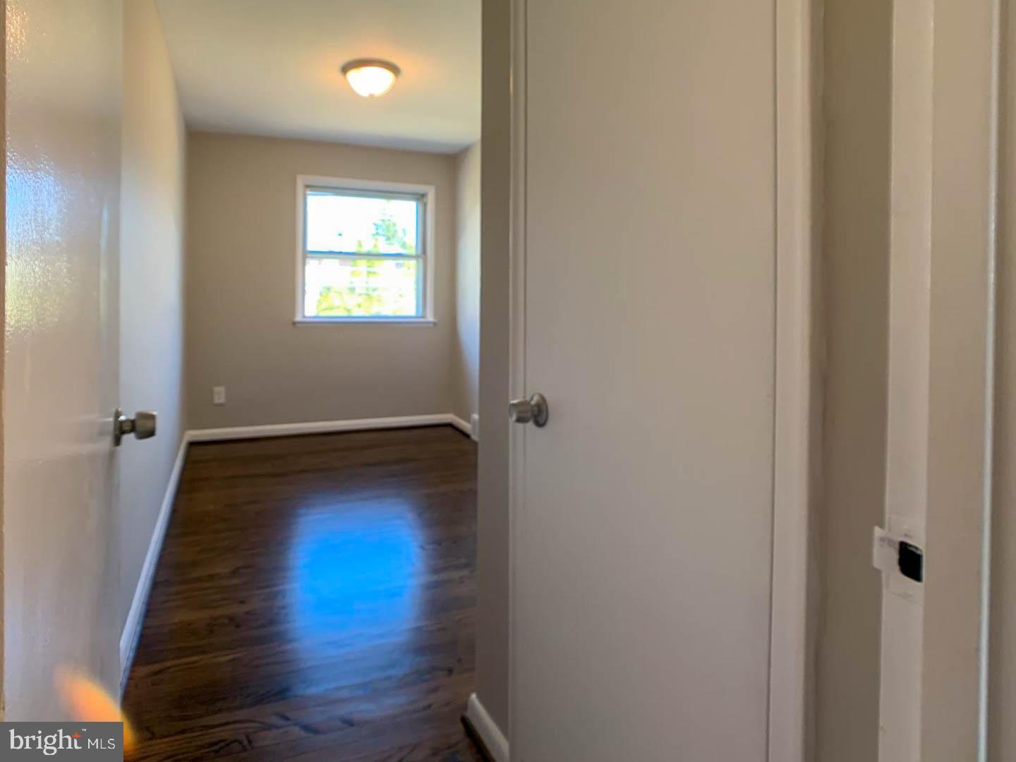 1567 Parklane Road Swarthmore, PA 19081 - Photo 20 of 23 a view of an empty room with wooden floor and a window
