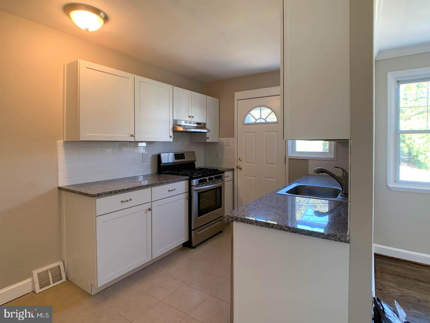 1567 Parklane Road Swarthmore, PA 19081 - Photo 3 of 23 a kitchen with cabinets appliances and a window