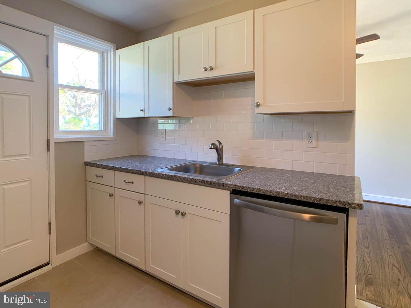 1567 Parklane Road Swarthmore, PA 19081 - Photo 5 of 23 a kitchen with granite countertop white cabinets and a sink