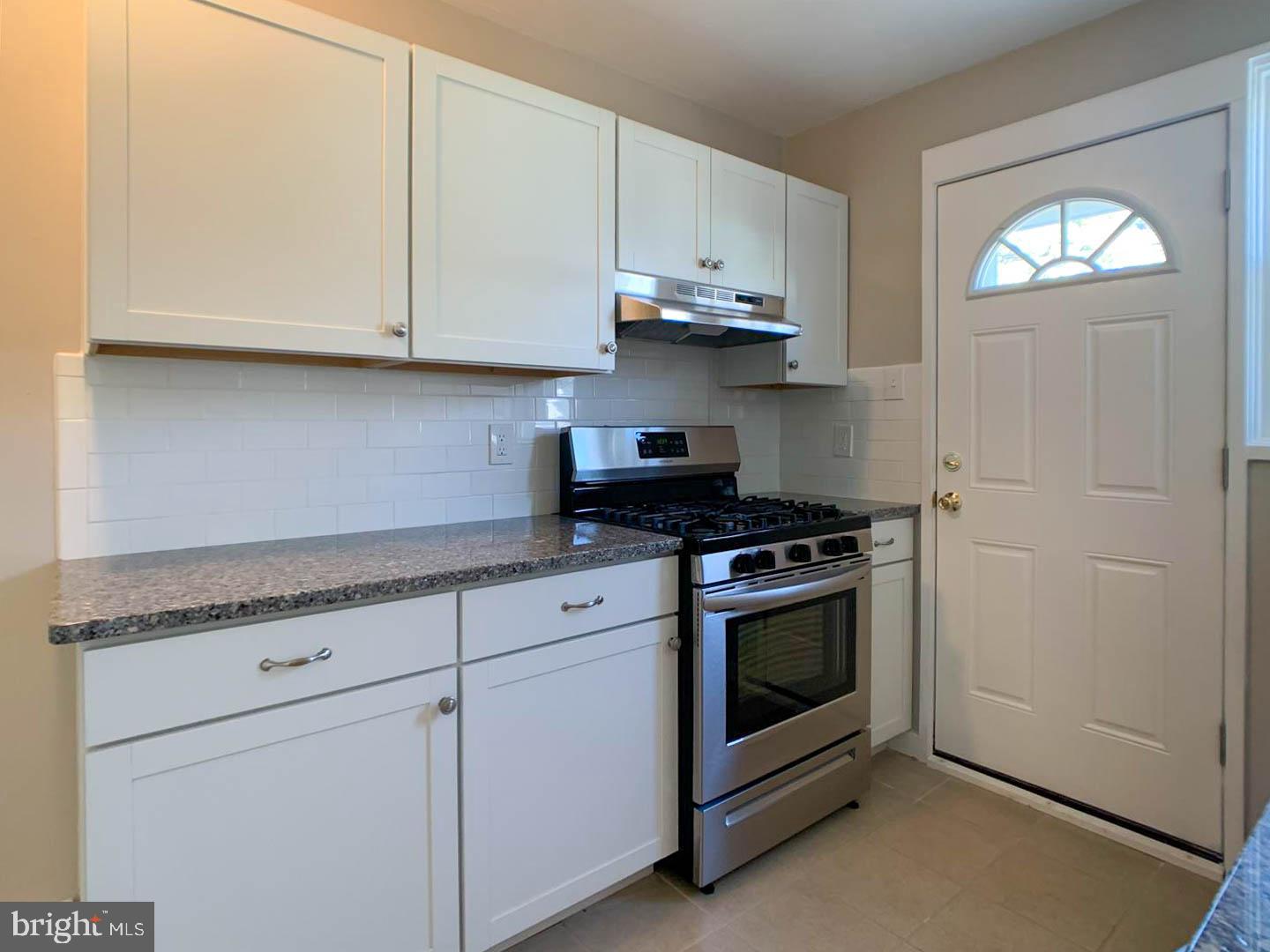 1567 Parklane Road Swarthmore, PA 19081 - Photo 6 of 23 a kitchen with granite countertop white cabinets and white appliances
