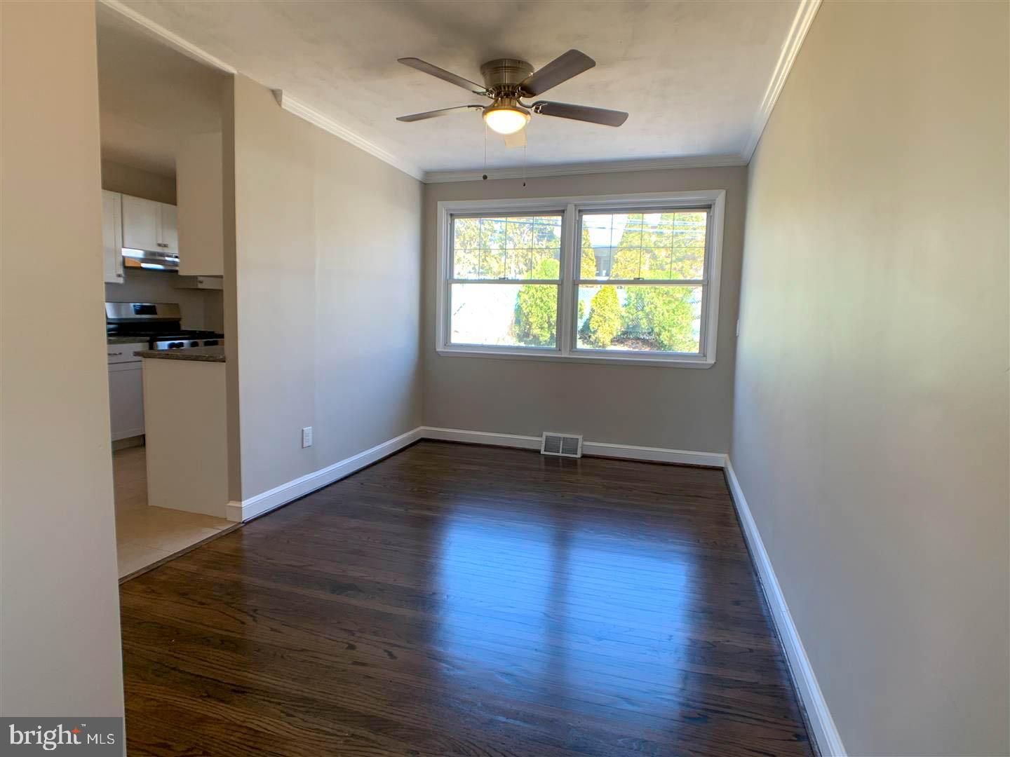 1567 Parklane Road Swarthmore, PA 19081 - Photo 8 of 23 wooden floor in an empty room with a window