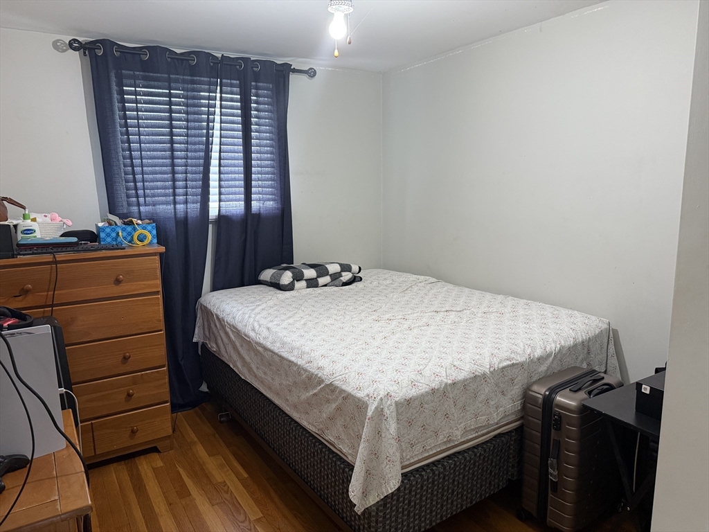 77 Roland Road Revere, MA 02151 - Photo 14 of 18 a bed sitting in a bedroom next to a window