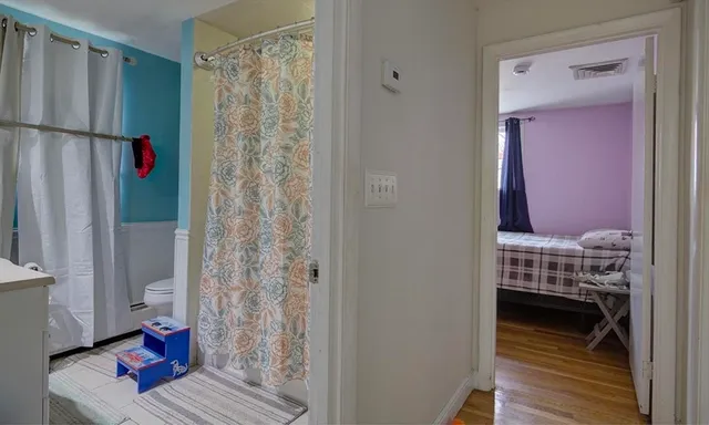 a view of bedroom with furniture and wooden floor