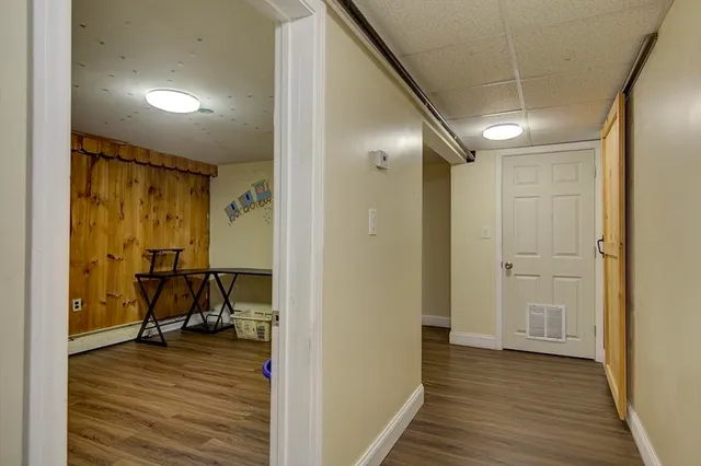 a view of a room with wooden floor and furniture