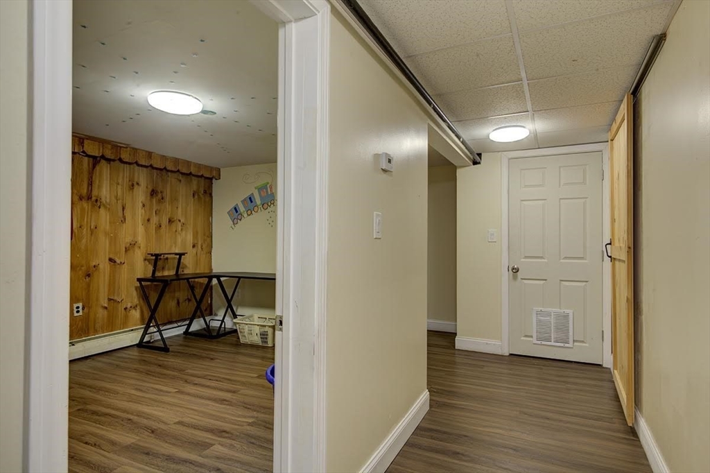 77 Roland Road Revere, MA 02151 - Photo 5 of 18 a view of a room with wooden floor and furniture