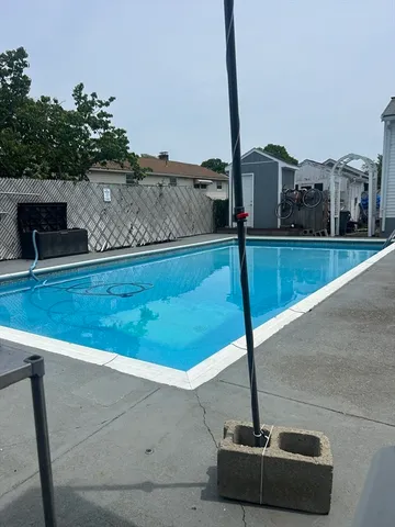 a view of swimming pool with a chair