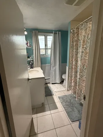 a kitchen with a table chairs refrigerator and cabinets