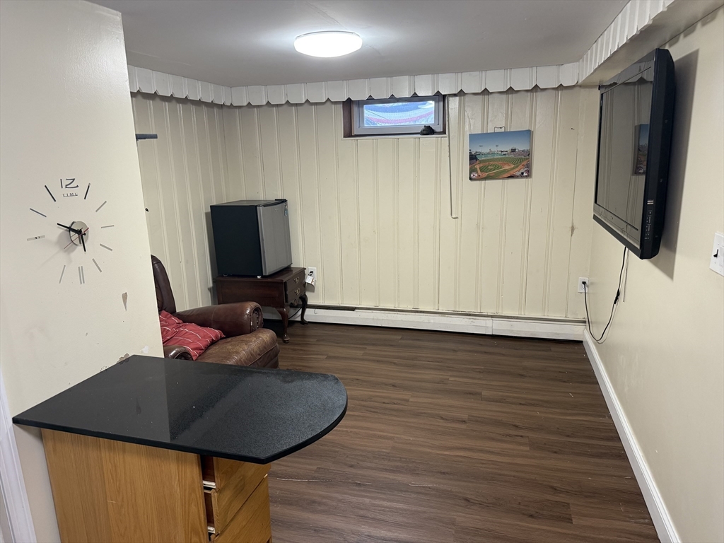 77 Roland Road Revere, MA 02151 - Photo 9 of 18 a living room with furniture and a flat screen tv