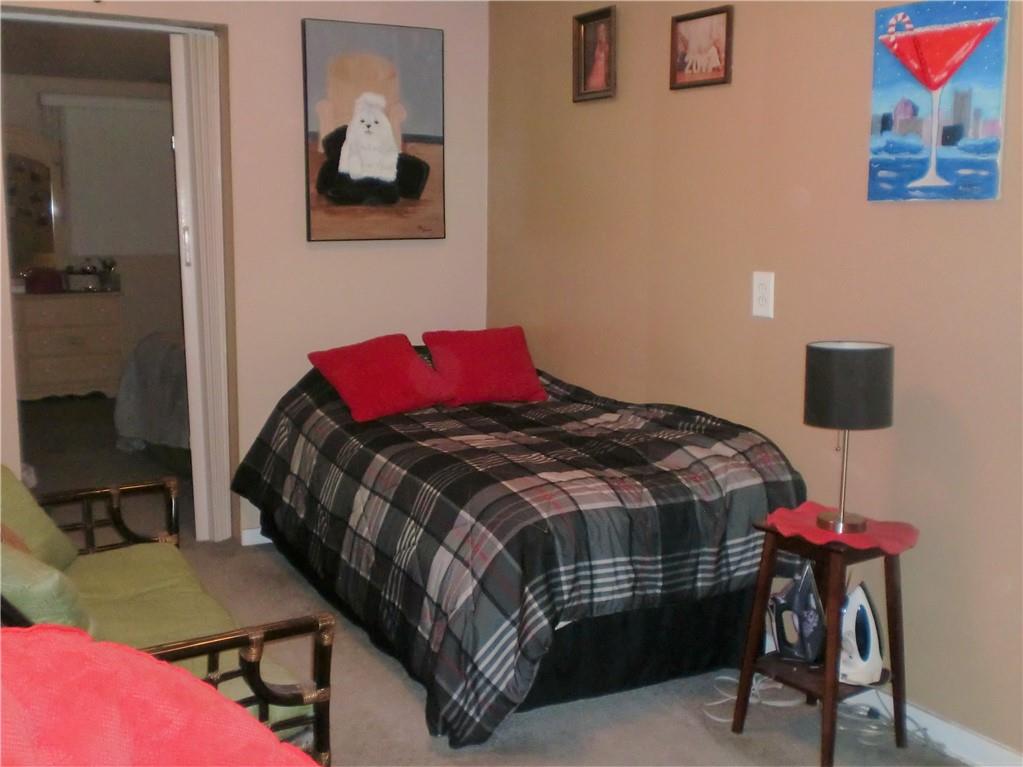 230 43rd Street Pittsburgh, PA 15201 - Photo 13 of 19 a bedroom with a bed and chair