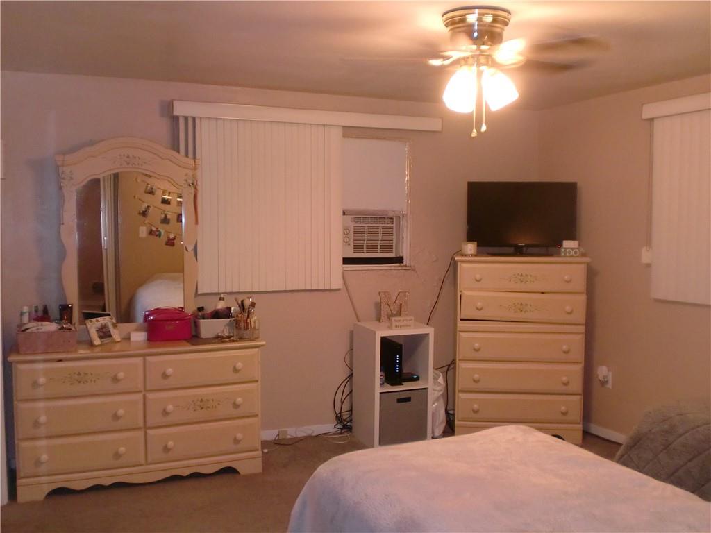 230 43rd Street Pittsburgh, PA 15201 - Photo 8 of 19 a bedroom with a bed and a flat tv screen on dresser