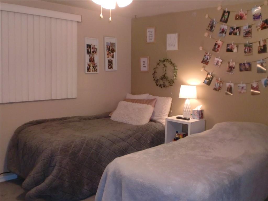 230 43rd Street Pittsburgh, PA 15201 - Photo 9 of 19 a bedroom with a bed and a lamp with window