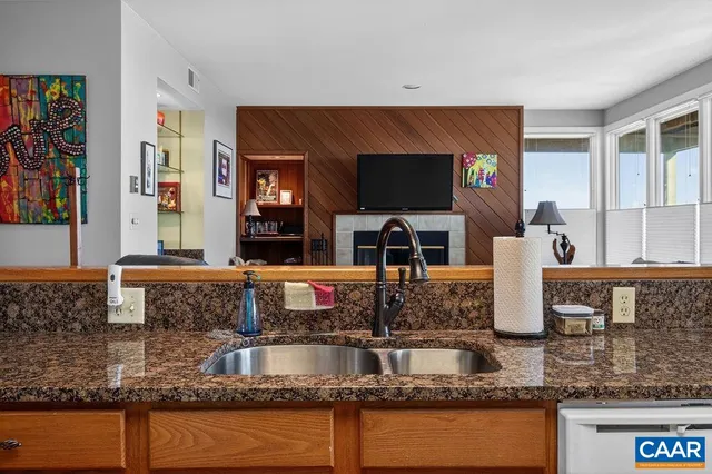 a kitchen with granite countertop stainless steel appliances wooden cabinet and a stove