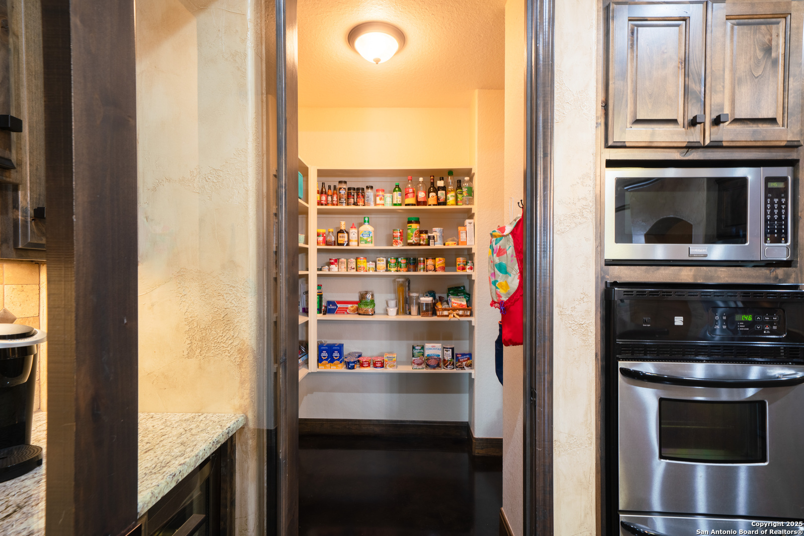 303 Schneider Street Poth, TX 78147 - Photo 17 of 41 a kitchen with a stove and a microwave