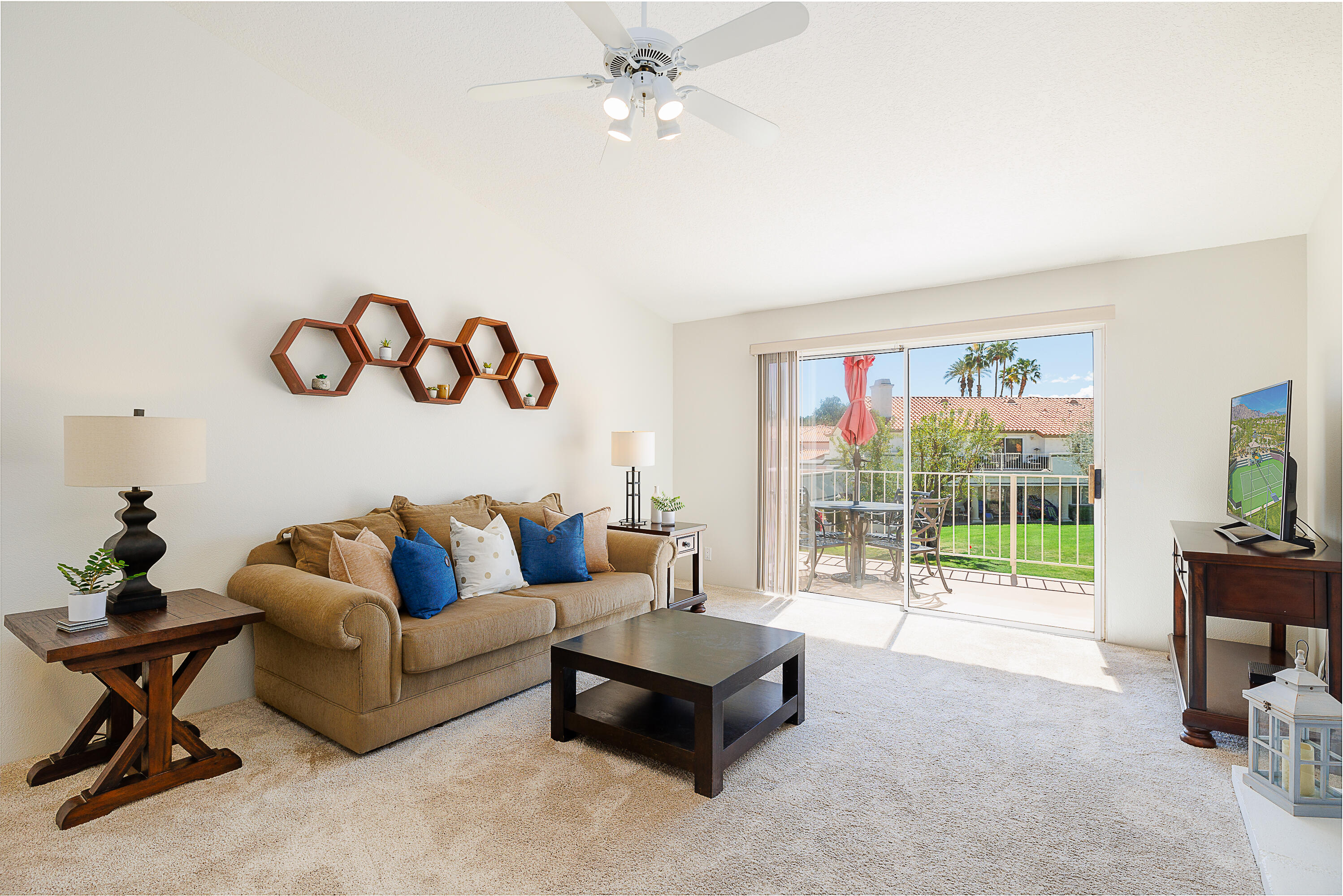 175 Firestone Drive Palm Desert, CA 92211 - Photo 2 of 24 a living room with furniture and a flat screen tv