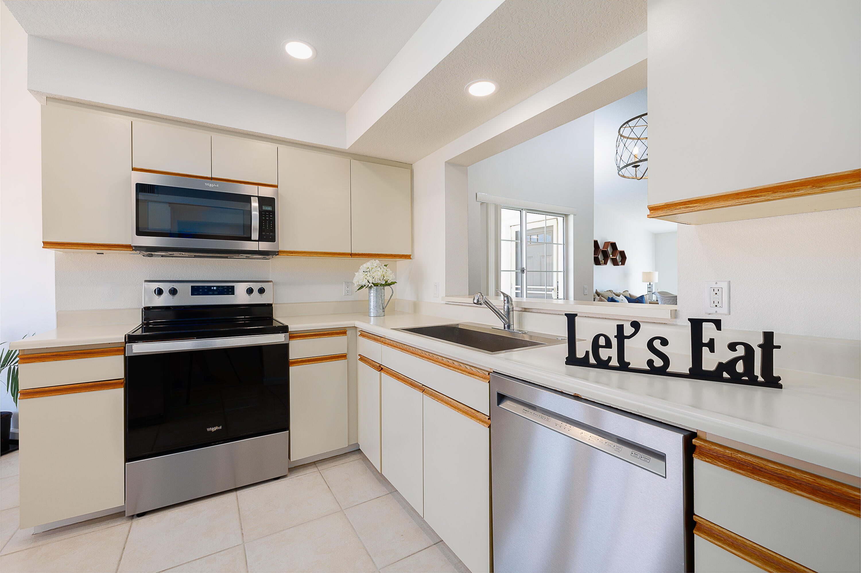 175 Firestone Drive Palm Desert, CA 92211 - Photo 6 of 24 a kitchen with a sink and steel appliances