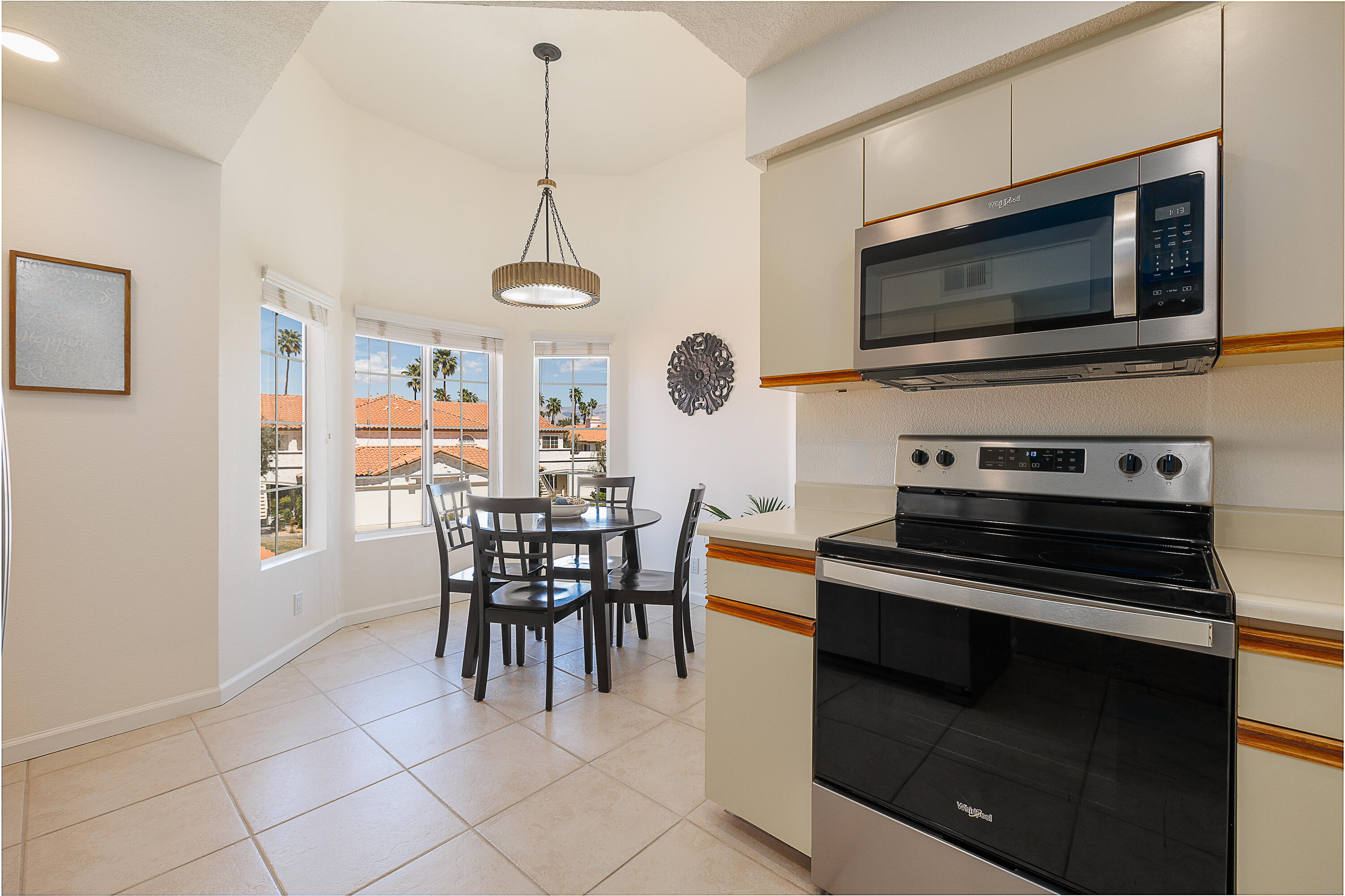 175 Firestone Drive Palm Desert, CA 92211 - Photo 7 of 24 a view of kitchen with microwave stove top oven and cabinets