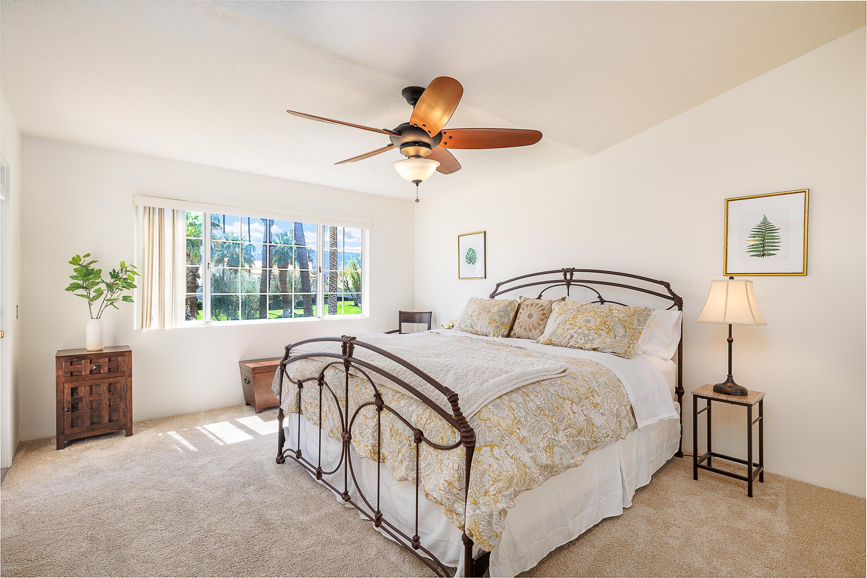 175 Firestone Drive Palm Desert, CA 92211 - Photo 9 of 24 a bedroom with a bed and a chandelier