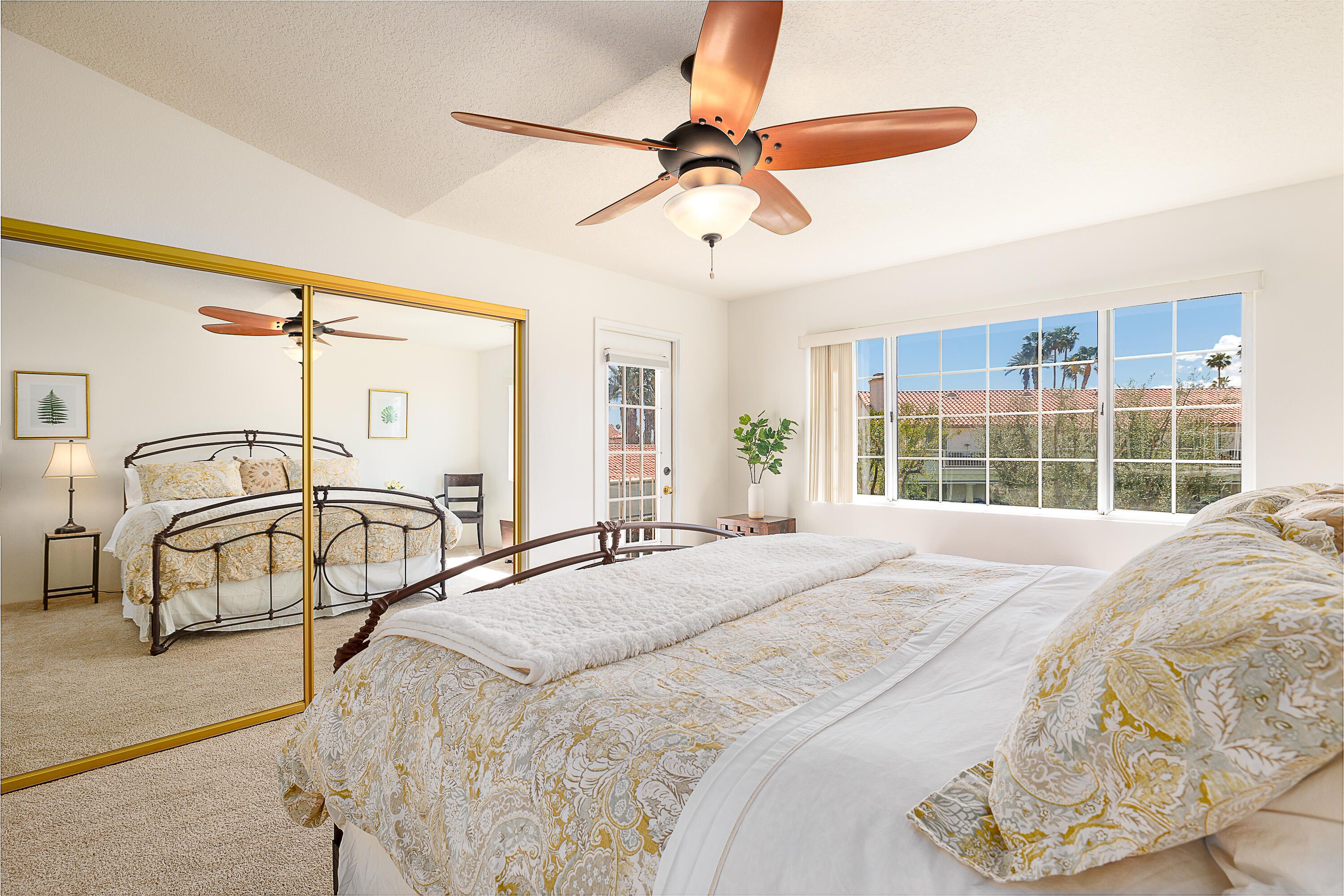 175 Firestone Drive Palm Desert, CA 92211 - Photo 10 of 24 a bedroom with a bed a window and ceiling fan