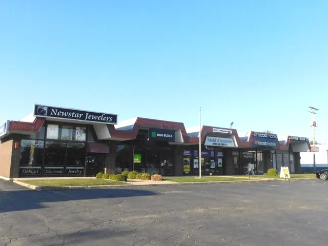 a view of a large building with a big yard and large trees