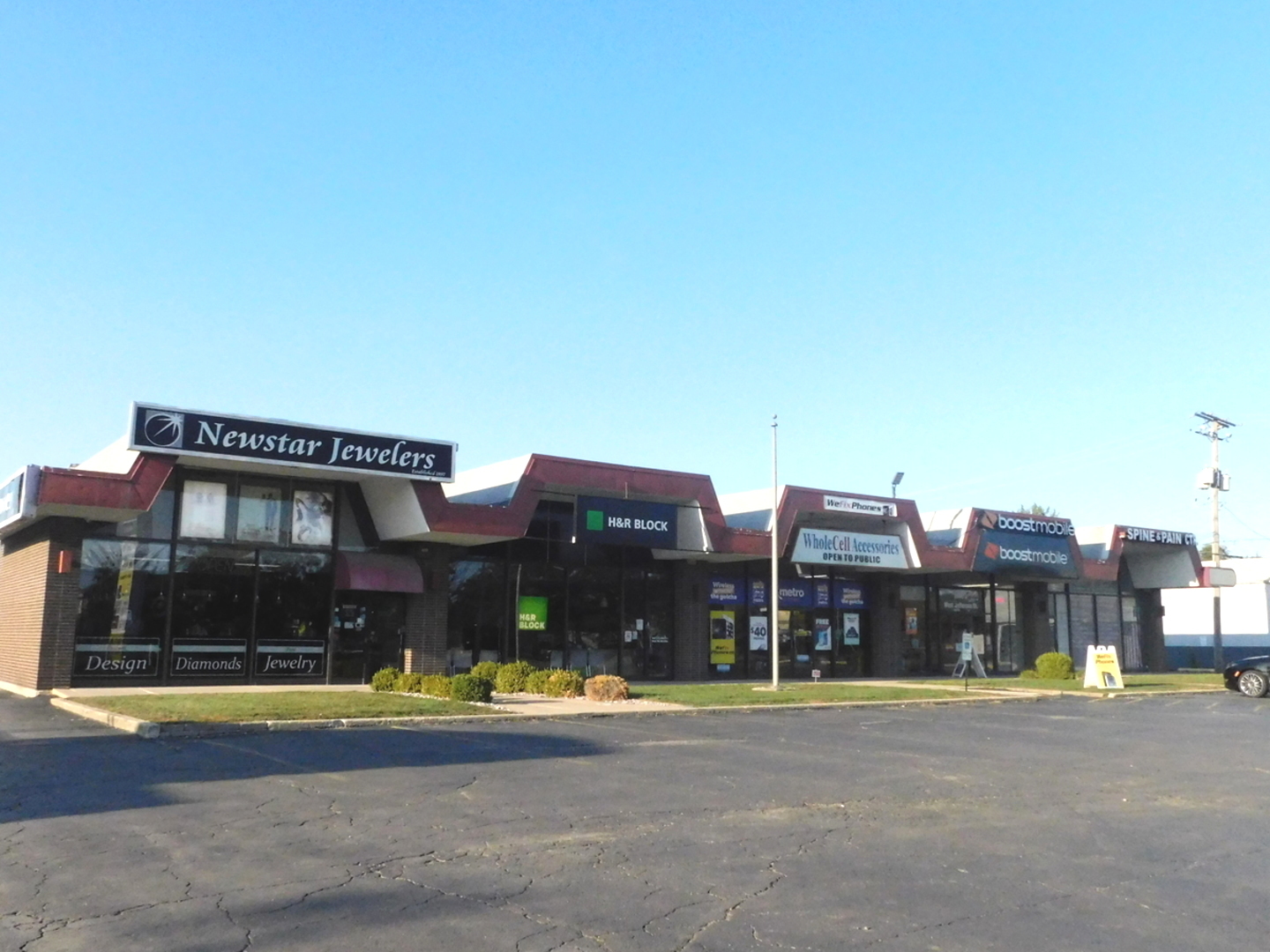 a view of a large building with a big yard and large trees