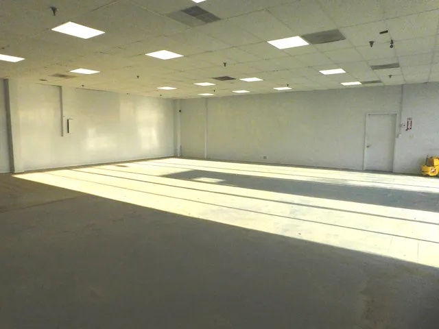 an empty room with a empty space and a window