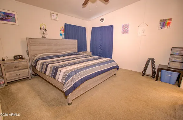 a bedroom with a bed and a window