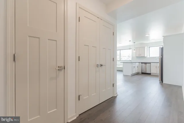a view of a kitchen with wooden floor and a sink