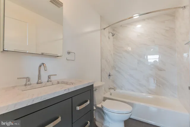 a bathroom with a sink a toilet and a bathtub
