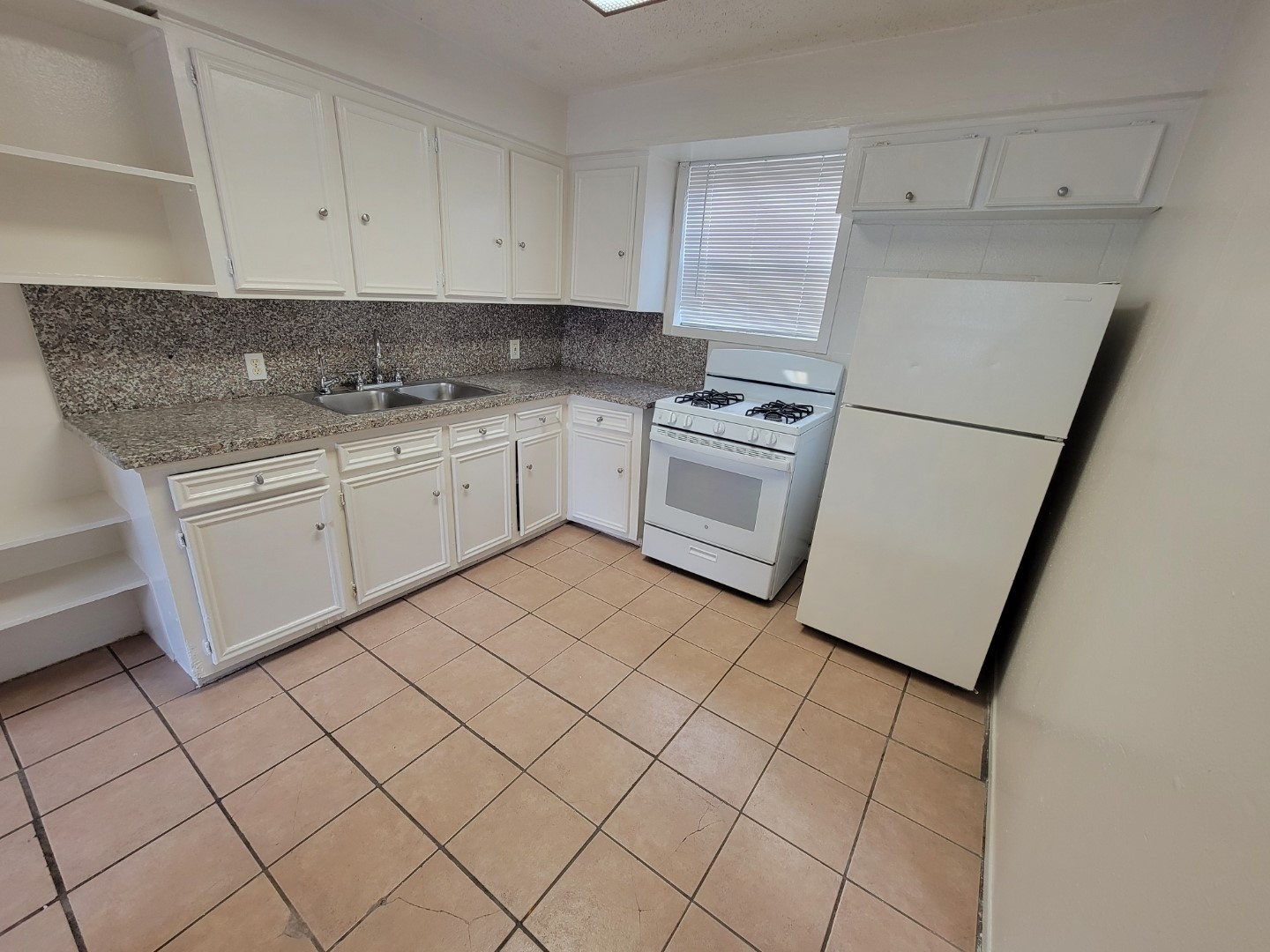 7124 Avenue I, Unit 2 Houston, TX 77011 - Photo 6 of 6 a kitchen with cabinets appliances and a sink