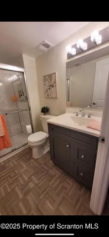 a bathroom with a sink mirror vanity and toilet