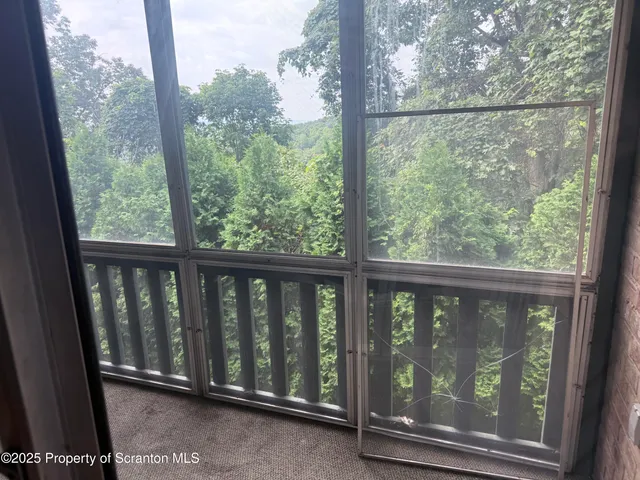 a view of a glass door with a balcony