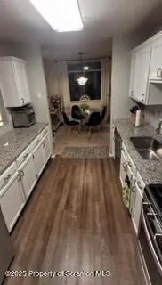 a kitchen with sink stove and cabinets