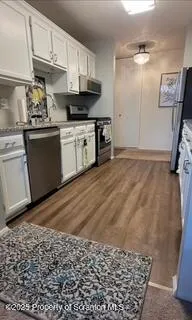 a kitchen with stainless steel appliances granite countertop a sink stove and cabinets
