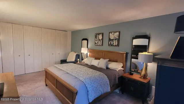 a bedroom with a bed and a lamp