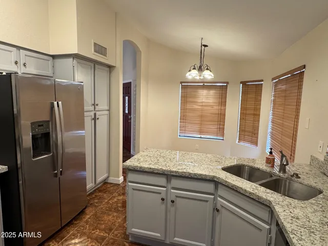 a kitchen with sink cabinets and refrigerator